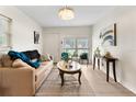 Bright and airy living room with neutral colors, modern decor and new flooring at 5115 W Livingston St, Orlando, FL 32811