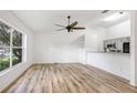 Bright living room with hard wood floors, ceiling fan, large window and open floor plan at 644 Villa Ct, Clermont, FL 34711