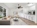 Bright open-concept living room showcasing modern decor and a seamless flow into the kitchen at 644 Villa Ct, Clermont, FL 34711