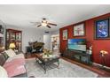 Cozy living room with wood floors, ceiling fan, and decorative artwork at 7466 Canford Ct # 25, Winter Park, FL 32792