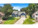 Charming blue home with a well-manicured lawn and inviting curb appeal in a beautiful setting at 7838 Rollingridge Ct, Orlando, FL 32835
