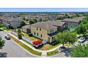 Aerial view of the home showcasing its landscaped backyard, white fence, and the surrounding neighborhood at 8057 John Hancock Dr, Winter Garden, FL 34787
