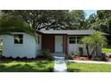 Exterior view of home with well-manicured lawn and tropical landscaping at 1011 W 16Th St, Sanford, FL 32771
