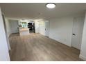 Open-concept living room leading into kitchen with stainless steel appliances, an island, and hardwood floors at 1011 W 16Th St, Sanford, FL 32771