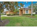 A beautifully landscaped front yard complements this single-story home with lush green grass at 1107 Carringdale Dr, Orlando, FL 32828