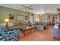 Spacious living room featuring wood flooring and stylish decor creating a cozy atmosphere at 1107 Carringdale Dr, Orlando, FL 32828