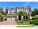 Beautiful two-story home boasting a manicured lawn, three-car garage, and appealing architectural elements at 12530 Climbing Vine Ct, Windermere, FL 34786