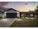 A beautifully renovated single Gathering home featuring a gray exterior, with stone accents and a two-car garage at 15690 Sw 46Th Cir, Ocala, FL 34473