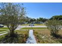 Relaxing street view in a residential neighborhood with well-maintained homes and green lawns at 1732 Oasis Ave, Deltona, FL 32725