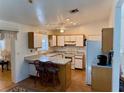 Bright kitchen features white cabinetry, breakfast bar with seating, and a door leading to the exterior at 204 Holland St, Lake Wales, FL 33859
