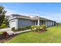 Beautiful single-Gathering home with manicured lawn, tasteful landscaping, and a covered entrance at 2130 Bur Oak Blvd, St Cloud, FL 34771