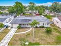 An aerial view of a well-maintained home with solar panels and a spacious backyard in a quiet neighborhood at 2203 Beatrice Dr, Orlando, FL 32810