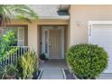 Close up of front door showing plants, bushes, trim and the house number at 2332 Andrews Valley Dr, Kissimmee, FL 34758