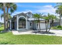 Charming single-Gathering home featuring a metal roof, a two-car garage and lush tropical landscaping at 2391 Piedmont Lakes Blvd, Apopka, FL 32703