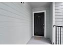 View of the front door of unit 1204 featuring a digital lock and a welcome mat at 2550 N Alafaya Trl # 2304, Orlando, FL 32826