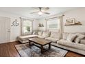 Inviting living room featuring a large sectional sofa, ceiling fan, and hardwood floors at 280 E Bay Ave, Longwood, FL 32750