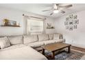 Inviting living room with a large sectional sofa, ceiling fan, and stylish decor at 280 E Bay Ave, Longwood, FL 32750