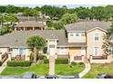 A birds-eye view of the property showing mature trees, multiple units and well maintained green spaces at 3249 Sandy Shore Ln, Kissimmee, FL 34743