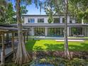 Beautiful backyard with pool, covered patio, and lush greenery providing privacy at 33 Eastwind Ln, Maitland, FL 32751