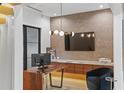 Stylish office with custom desk, designer wall, and elegant lighting at 33 Eastwind Ln, Maitland, FL 32751