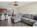 Inviting living room featuring wood-look flooring, a ceiling fan and a comfortable sectional couch at 3816 Tram Ct, Orlando, FL 32810