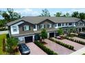 Beautiful townhouse exterior with brick driveways, manicured landscaping and attached garages at 391 Cape Honeysuckle Pl, Sanford, FL 32771