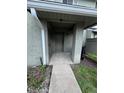 Inviting condo entrance featuring a concrete walkway, neutral-colored exterior, and visible unit number at 4596 Pheasant Run Dr # C, Orlando, FL 32808