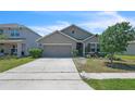 Charming single-story home with a well-maintained lawn, two car garage and a neatly landscaped garden at 5234 Bear Corn Run, Port Orange, FL 32128