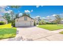 Paver driveway leads to a garage with a charming architectural detail at 623 Tuskawilla Point Ln, Winter Springs, FL 32708