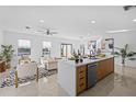 Open-concept kitchen with island seating, seamlessly integrated with the living area and scenic backyard views at 6419 Chorus Dr, Mascotte, FL 34753