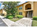 Inviting two-story condo featuring well-maintained landscaping and a charming arched entryway at 758 E Michigan St # 203, Orlando, FL 32806