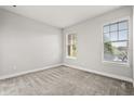 Bright bedroom with carpet and two windows providing natural light at 7724 Sweet Star Ave, Orlando, FL 32836