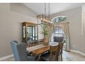 Traditional dining room with wooden table set, stylish chandelier, and elegant display cabinet at 824 Spring Island Way, Orlando, FL 32828