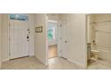 Inviting foyer with tiled floors, showcasing a hallway, bathroom and bright living space at 868 Brooklet Dr, Davenport, FL 33837