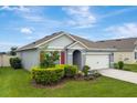 Charming home showcasing lush landscaping, a two-car garage and a well-maintained lawn at 868 Brooklet Dr, Davenport, FL 33837