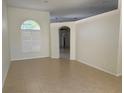 Bright living room with tile flooring, neutral walls, and arched doorway at 10955 Lemay Dr, Clermont, FL 34711