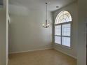 Open-concept living area with tile flooring, chandelier, and plenty of natural light at 10955 Lemay Dr, Clermont, FL 34711