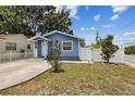Charming blue single-story home featuring a well-manicured yard and a inviting front entrance at 1432 Selma Ave, Orlando, FL 32825