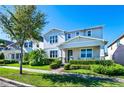 Charming two-story home featuring mature landscaping and a well-maintained lawn on a sunny day at 14753 Snowy Egret St, Winter Garden, FL 34787
