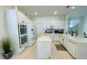 Bright kitchen features white cabinetry, stainless appliances, and center island at 14753 Snowy Egret St, Winter Garden, FL 34787