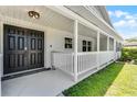 Welcoming front porch featuring a double door entrance, fresh white paint, and classic architecture at 174 Pine Grove Ct, Daytona Beach, FL 32119