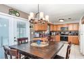Eat-in kitchen with wooden cabinets, granite countertops and stainless steel appliances at 1962 English Dr, Deltona, FL 32738