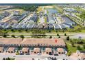 Aerial view of townhomes with private screened-in patios, landscaping, and community amenities at 1979 Majorca Dr, Kissimmee, FL 34747