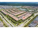 Extensive community with a central lake, a pool, landscaping, and numerous townhomes at 1979 Majorca Dr, Kissimmee, FL 34747