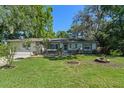 Well-maintained single-story residence with a beautiful lawn, trees, and an attached garage at 216 San Fernando Ct, Sanford, FL 32773