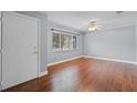 Bright living room featuring hardwood floors, a ceiling fan, and a large window at 216 San Fernando Ct, Sanford, FL 32773