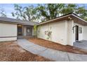 Exterior angle view of the entrance with a screened in porch at 22 Hillcrest Dr, Babson Park, FL 33827