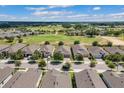 High angle aerial view of multiple homes with a well-maintained golf course behind them at 2233 Antilles Club Dr, Kissimmee, FL 34747