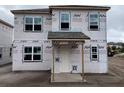 New construction features a two-story house with a covered porch and installed windows at 2365 Zuni Road, St Cloud, FL 34771