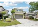 Beautiful two-story home with a well-manicured lawn and inviting two-car garage on a sunny day at 2850 Pewter Mist Ct, Oviedo, FL 32765